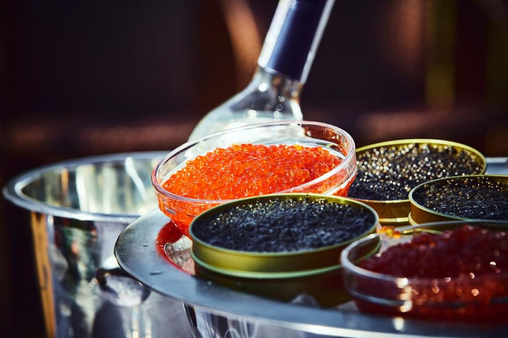 Several types of caviar sit side by side in a formal caviar service