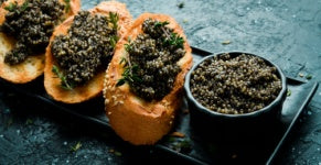 Caviar on toast atop a stone countertop