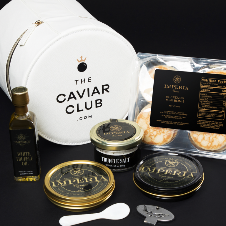 Caviar Club gift set with two Imperia tins, truffle salt, white truffle oil, French blinis, pearl spoon, and leather pouch.