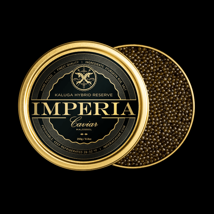 Open 250g tin of Imperia Kaluga Hybrid Reserve Caviar with dark amber pearls and branded black and gold lid on a black background.