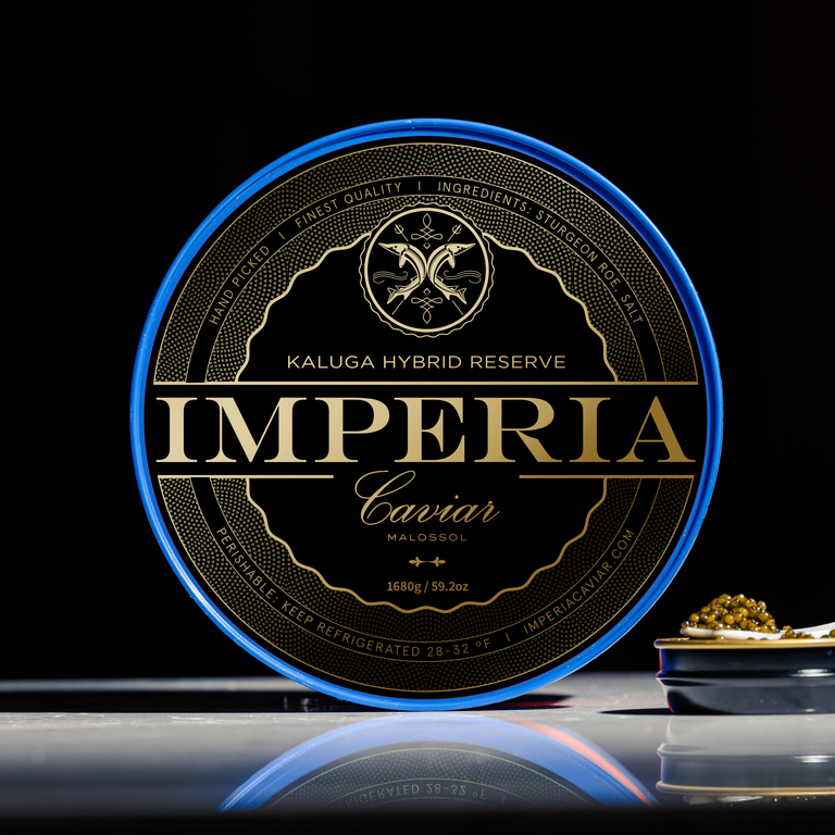 Imperia Kaluga Hybrid Reserve 1680g party tin with blue rim and black and gold label, with a caviar canapé beside it.